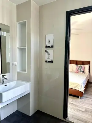 a bathroom with a sink and a bed at Laguna villa with private pool in Ban Phru Champa
