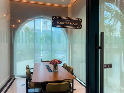 a meeting room with a table and chairs and a sign at Title Legendary Apartment 1 Bdr Bang Tao in Bang Tao Beach