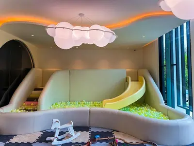 a childrens play room with a slide at Title Legendary Apartment 1 Bdr Bang Tao in Bang Tao Beach