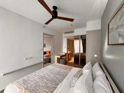 a bedroom with a bed and a ceiling fan at Cassia Residences Condo in Laguna Phuket in Laguna Phuket