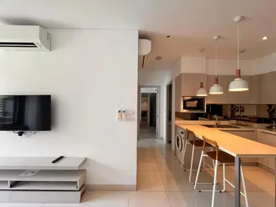 a kitchen with white walls and a wooden counter top at Cassia Residences Condo in Laguna Phuket in Laguna Phuket