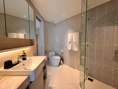 a bathroom with a sink and a shower and a toilet at Cassia Residences Condo in Laguna Phuket in Laguna Phuket