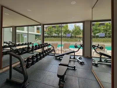 a gym with a row of treadmills and machines at The Ozone Residences Bangtao Beach 1Bdr in Laguna Phuket