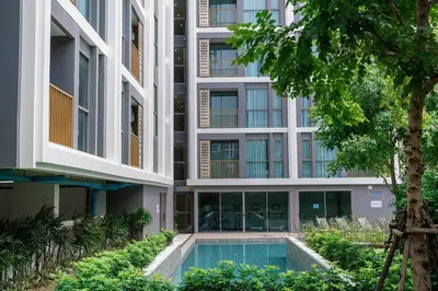 an external view of a building with a swimming pool at The Ozone Residences Bangtao Beach 1Bdr in Laguna Phuket