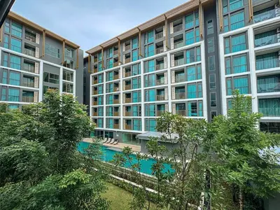 an apartment building with a pool in front of it at The Ozone Residences Bangtao Beach 1Bdr in Laguna Phuket