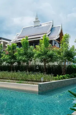 a building with a swimming pool in front of a building at The Ozone Residences Bangtao Beach 1Bdr in Laguna Phuket