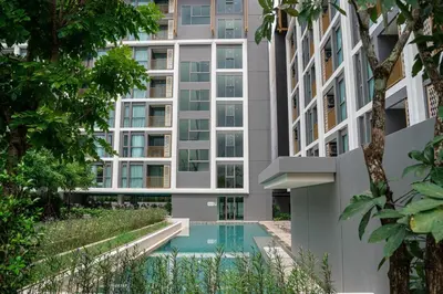 an apartment building with a swimming pool in front of it at The Ozone Residences Bangtao Beach 1Bdr in Laguna Phuket