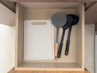 a cupboard with some kitchen utensils in it at Lovely 2 Bdr Canvas BangTao in Laguna Phuket