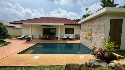 a swimming pool in front of a house at Lai Thai Villa 4 in Rawai Beach