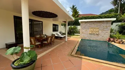a house with a swimming pool and a dining room at Lai Thai Villa 4 in Rawai Beach