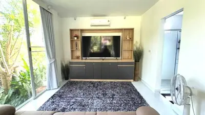 a living room with a flat screen tv and a rug at Lai Thai Villa 4 in Rawai Beach