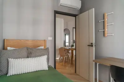 a bedroom with a bed and a dining room at Suite Valencia 2BR The Title IBG Legendary BangTao in Laguna Phuket