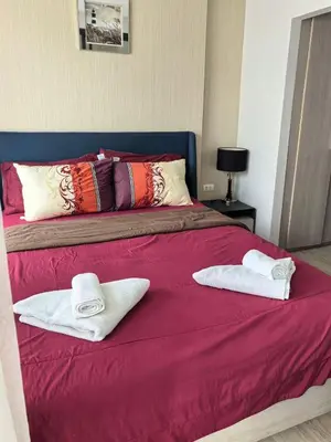 a bed with two towels on top of it at Centrio phuket 07 in Ban Rangeng