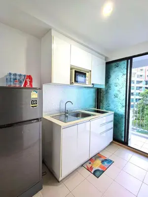 a kitchen with a sink and a refrigerator at Centrio phuket 07 in Ban Rangeng