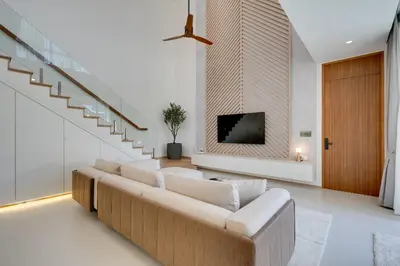 a living room with a couch and a flat screen tv at New 4 bedroom villa 700 meters to Bang Tao Beach in Ban Thalat Choeng Thale