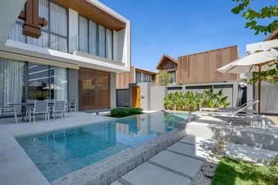 a swimming pool in front of a house at New 4 bedroom villa 700 meters to Bang Tao Beach in Ban Thalat Choeng Thale