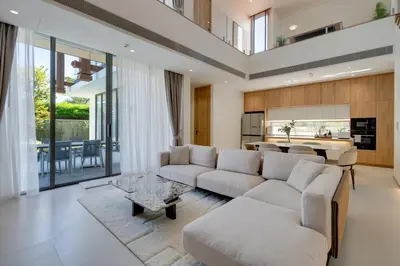 a living room with a couch and a table at New 4 bedroom villa 700 meters to Bang Tao Beach in Ban Thalat Choeng Thale