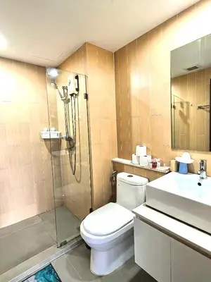 a bathroom with a toilet and a shower and a sink at centrio Phuket A68 in Ban Rangeng