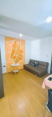 a living room with a couch and a table at centrio Phuket A68 in Ban Rangeng
