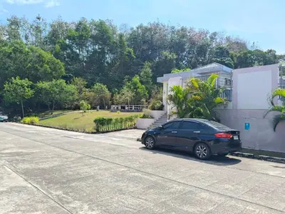 a black car parked in front of a house at Jenny Naiyang Beach in Phuket