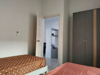 a bedroom with a bed and a closet at Jenny Naiyang Beach in Phuket