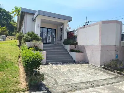 a house with stairs leading to a door at Jenny Naiyang Beach in Phuket