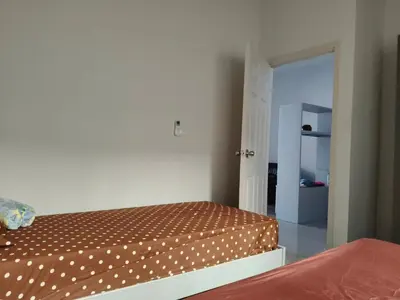 a bedroom with a bed and an open door at Jenny Naiyang Beach in Phuket