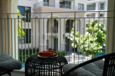 a bowl of watermelon on a table on a balcony at Luxury 2 bdr Title Legendary Bang Tao Pool View in Bang Tao Beach