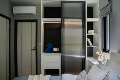 a living room with a stainless steel refrigerator at Luxury 2 bdr Title Legendary Bang Tao Pool View in Bang Tao Beach