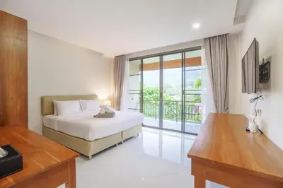 a hotel room with a bed and a balcony at 1 Bedroom Villa - 2 Minutes to Nai Harn Beach A103 in Rawai Beach