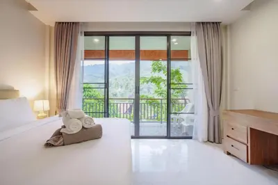 a bedroom with a bed with towels on it at 1 Bedroom Villa - 2 Minutes to Nai Harn Beach A103 in Rawai Beach