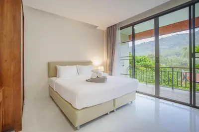 a bedroom with a large bed and a large window at 1 Bedroom Villa - 2 Minutes to Nai Harn Beach A103 in Rawai Beach