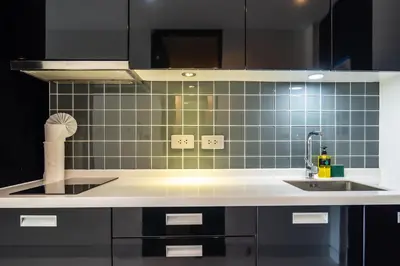 a kitchen with a sink and a blue tiled wall at Sea view studio near Tri Trang & Merlin beach in Patong Beach