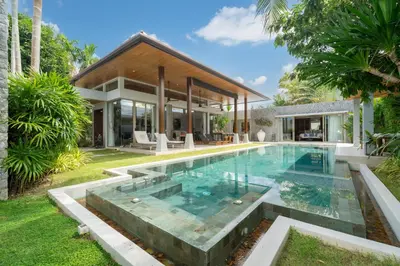 an infinity pool in the backyard of a house at Villa love with a garden in Phuket