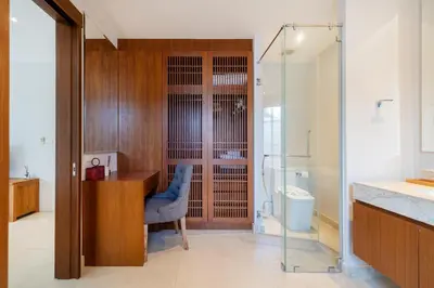 a bathroom with a wooden desk and a blue chair at Villa love with a garden in Phuket