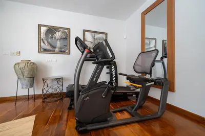 a gym with a treadmill and a mirror at Villa love with a garden in Phuket
