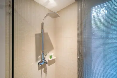 a shower in a bathroom with a glass window at Villa love with a garden in Phuket