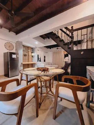 a kitchen and living room with a table and chairs at The Lighthouse Seaview Hotel in Rawai Beach