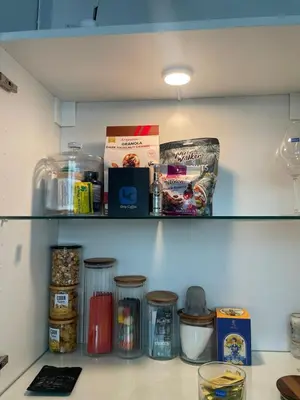 a shelf in a kitchen with food items on it at The Lighthouse Seaview Hotel in Rawai Beach