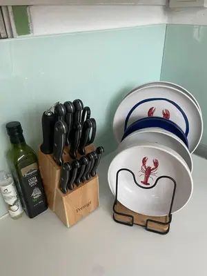 a mortar and pestle next to a knife block at The Lighthouse Seaview Hotel in Rawai Beach