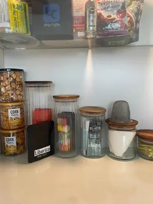 a refrigerator shelf with jars of food on it at The Lighthouse Seaview Hotel in Rawai Beach