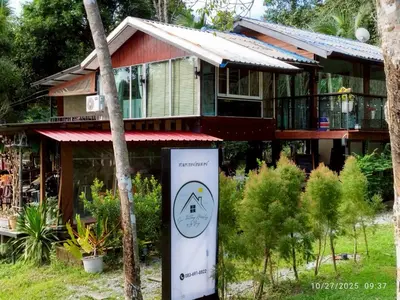 a house with a sign in front of it at Suan Tha-Thong Homestay in Ban Bang Pla
