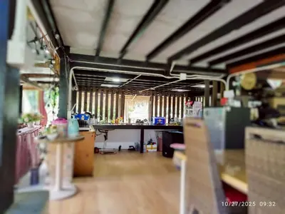 a large room with a desk and a room with a table at Suan Tha-Thong Homestay in Ban Bang Pla
