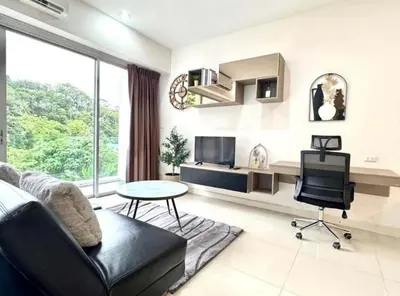 a living room with a couch and a table at Chic condominimum in Karon Beach