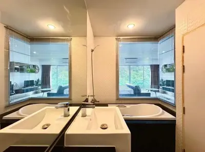 a bathroom with two sinks and a tub and two windows at Chic condominimum in Karon Beach