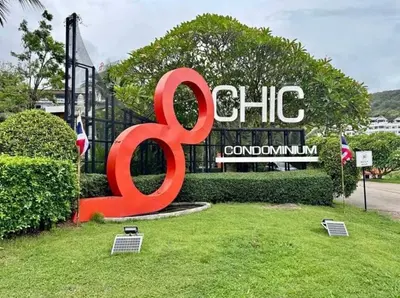 a large red sign in front of a building at Chic condominimum in Karon Beach