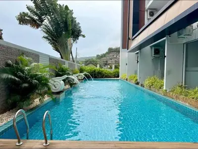 a swimming pool in the middle of a building at Chic condominimum in Karon Beach