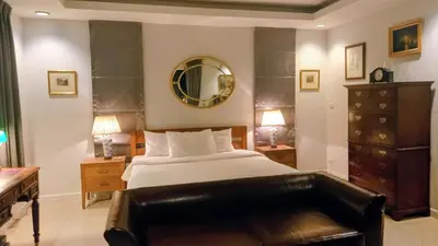 a bedroom with a bed and a mirror at 4-Bedroom cozy pool villa in the heart of Bang Tao in Laguna Phuket