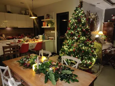 a christmas tree in a kitchen with a wooden table at 4-Bedroom cozy pool villa in the heart of Bang Tao in Laguna Phuket