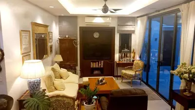 a living room with a couch and a table at 4-Bedroom cozy pool villa in the heart of Bang Tao in Laguna Phuket